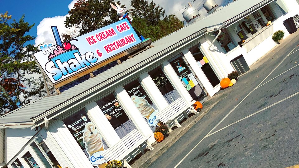 Outdoor seating beside a casual restaurant counter.